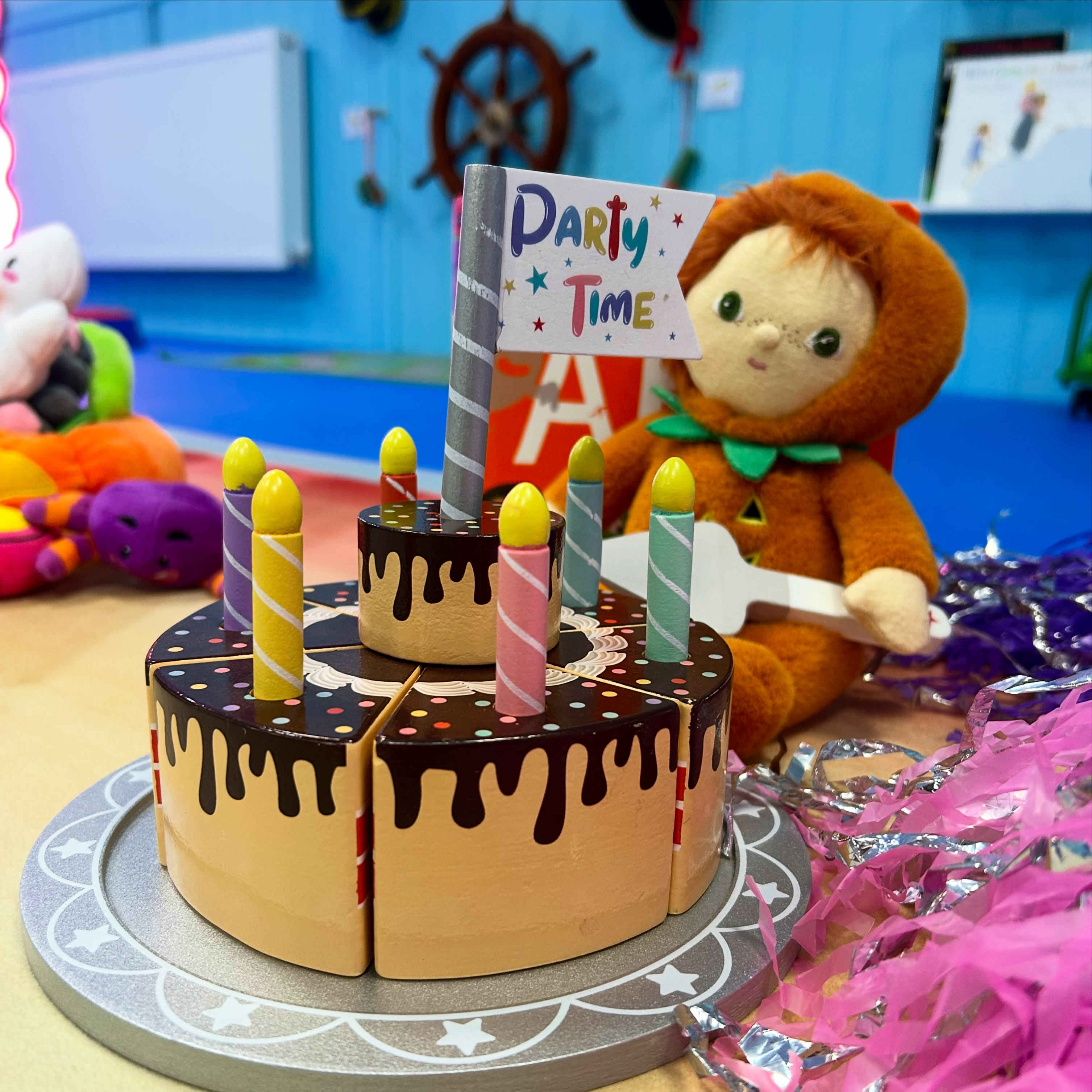 A toy birthday cake with a Party Time flag at The Little Harbour